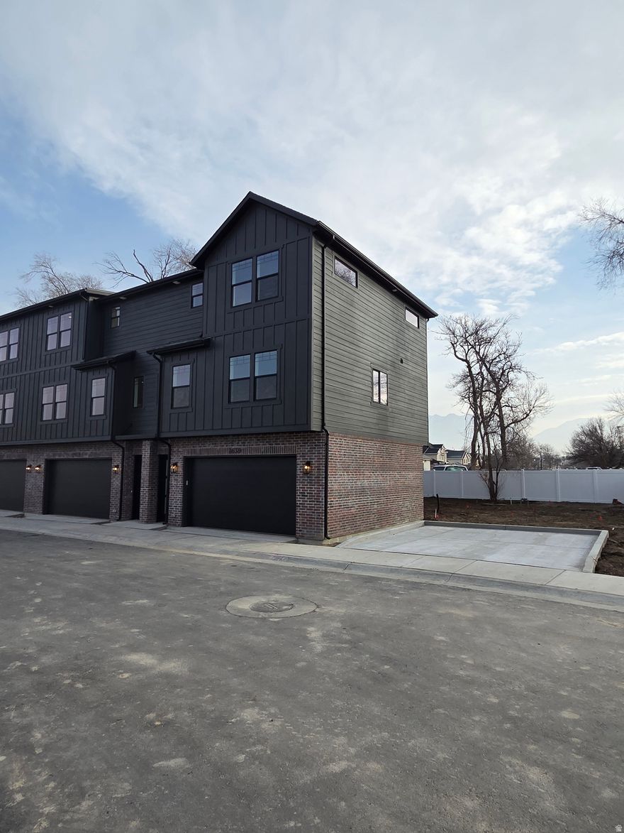 Welcome to this exceptional town home in a highly sought-after new Sandy neighborhood. Situated on a tranquil dead-end street with zero through traffic, this home offers the perfect blend of privacy and serenity you've been searching for. Step inside to discover a beautifully designed open floor plan that seamlessly connects living spaces, ideal for both everyday living and entertaining. High-end finishes throughout showcase meticulous attention to detail and quality craftsmanship. The rich hardwood floors flow elegantly across the main living areas, while the gourmet kitchen features LG stainless steel appliances.  Every element has been carefully selected to create a sophisticated yet welcoming atmosphere. The spacious master suite provides a luxurious private retreat, complemented by two generous guest bedrooms perfect for family, visitors, or a home office. The extra-large garages offer abundant space not just for vehicles, but also extensive storage to keep your home organized and clutter-free. Location couldn't be better. Enjoy the convenience of walking distance to schools, making morning drop-offs a breeze. Quick freeway access ensures an easy commute, while nearby shopping centers put everything you need just minutes away. You'll love the balance of peaceful residential living with unbeatable access to all essential amenities. Experience the perfect combination of modern elegance, thoughtful design, and peaceful living in an unbeatable location. Don't miss this rare opportunity to call this exceptional property home.