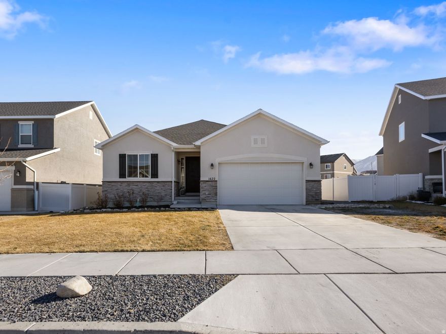 This stunning Tooele rambler offers the perfect blend of space, style, and functionality. This home has a like-new feel with vaulted ceilings and an open, inviting layout. The spacious kitchen is a showstopper with quartz countertops, a large island, gas stovetop, double oven, soft closing cabinets and drawers, and the perfect nook dining area-ideal for everyday living and entertaining. Luxury details like vinyl plank LVP flooring on the main floor, and waterproof flooring in the basement, separate tub and shower on the master bath, walk in closet and so much more!. The incredibly spacious finished basement has unlimited potential.  Step outside to enjoy the covered patio, low-maintenance yard, and convenient RV parking. A rare find that checks all the boxes for comfort, space, and modern living. No HOA!.