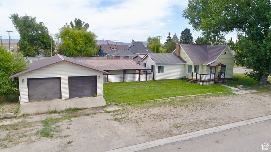 ANOTHER $10K PRICE DROP!! This Quaint Country Home is Calling Your Name! If You've Been Searching for An Affordable Home with a Lot of Shop Space, Storage Space, and Parking Space Then THIS is The Home for You! Featuring 2 Beds, 1 Bath, a Large Living Room with an Archway Leading into the Dining Room, Separate Laundry Room, and Lots of Space for Storage in the Basement. One Room is Being Used as a Living Space but Could Easily be Used as a Large Master Bedroom with a Separate Entrance. The Detached Heated Garage Offers Space for 4 Cars and A Workbench for Projects. Connected to the Garage is an Additional Large Storage and Workshop Area. The New Sod is Growing Well in the Yard, the Backyard is Completely Fenced so it's Ready for Your Pets, and You'll Already Have an Operational Chicken Coop! Additional Parking Space West of the Garage Would Be Great for Extra Storage Space as Well. Call Listing Agent Today to Schedule Your Private Showing.