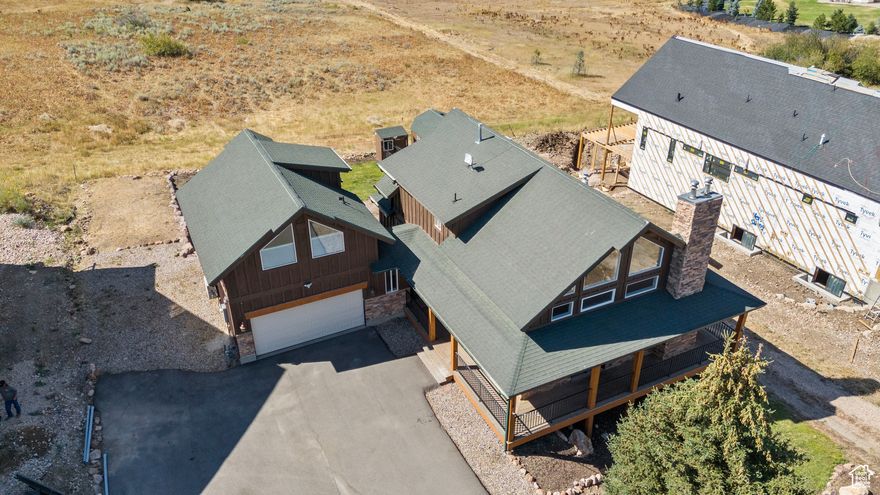 Discover unmatched flexibility and timeless mountain charm in this beautifully crafted home in The Preserve - just minutes from three major ski resorts, hiking and biking trails, boating, golfing, and more. This home offers three separate lock-off areas with their own private entrances - perfect for generating rental income, hosting guests, or multi-generational living, or enjoy the entire space as a single-family retreat. Inside, you'll find vaulted plank ceilings, rich hardwood flooring, and abundant natural light through large windows framing sweeping mountain views. The main-level primary suite offers a cozy fireplace, jetted tub, double-wide shower, and private covered deck with views of Nordic Valley Ski Resort. Upstairs includes a lofted family room, two bedrooms, and a full bath. The finished lower level offers a full kitchen, living area, bedroom, bathroom, and walk-out access - ideal as a private apartment or entertainment space. Above the detached two-car garage, a charming studio apartment features its own kitchenette, bathroom, and living area. The Preserve community offers a park, playground, bowery, and scenic paved trails along the North Fork seasonal river. Whether you're seeking a year-round residence, vacation retreat, or investment opportunity, this home delivers endless possibilities - all set against Utah's most spectacular mountain backdrop.