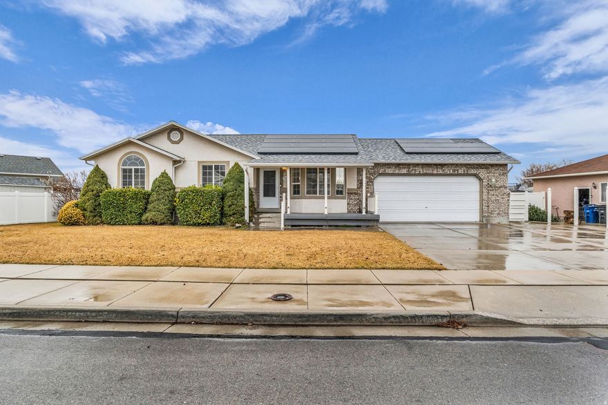 This awesome rambler offers SINGLE-LEVEL LIVING, flexible space, and outstanding functionality, ideal for owner-occupants, MULTI-GENERATIONAL LIVING, or RENTAL INCOME potential.  Major improvements include a roof and solar panels installed in early 2020, along with an HVAC system (furnace and air conditioner) and water heater that are approximately four years old. The home features new paint throughout and brand-new carpet, making it truly move-in ready. The solar system helps reduce monthly energy costs, and the recently added Govee permanent outdoor lighting enhances curb appeal, visibility, and year-round exterior ambiance.  The main level features convenient laundry, a primary bedroom with a walk-in closet and private bath. Downstairs, the walkout basement with a separate entrance is exceptionally well positioned for an ADU, mother-in-law apartment, or rental setup. Plumbing is already in place for a future kitchen, with easy options for adding a range, washer and dryer, sink, microwave, and refrigerator. The basement living area has room to add an additional bedroom, allowing for a potential five-bedroom configuration, along with extra den or office space for added flexibility.  Outside, the property features a massive 30' x 30' garage, dedicated RV parking with a power connection, and extended side parking capable of accommodating vehicles up to 40 feet or more. Enjoy beautiful views from the deck and take advantage of the current above-ground pool setup, which is fully portable and can be enjoyed as is, removed for expanded deck enjoyment, or upgraded to suit your needs. With quick access to Mountain View Corridor and Bangerter Highway while still tucked away in a quieter, off-the-beaten-path setting, this home offers versatility, upgrades, and space that are increasingly hard to find. Schedule your showing today and make this home yours.  Square footage figures are provided as a courtesy estimate only and were obtained from county records.  Buyer is advised to obtain an independent measurement.