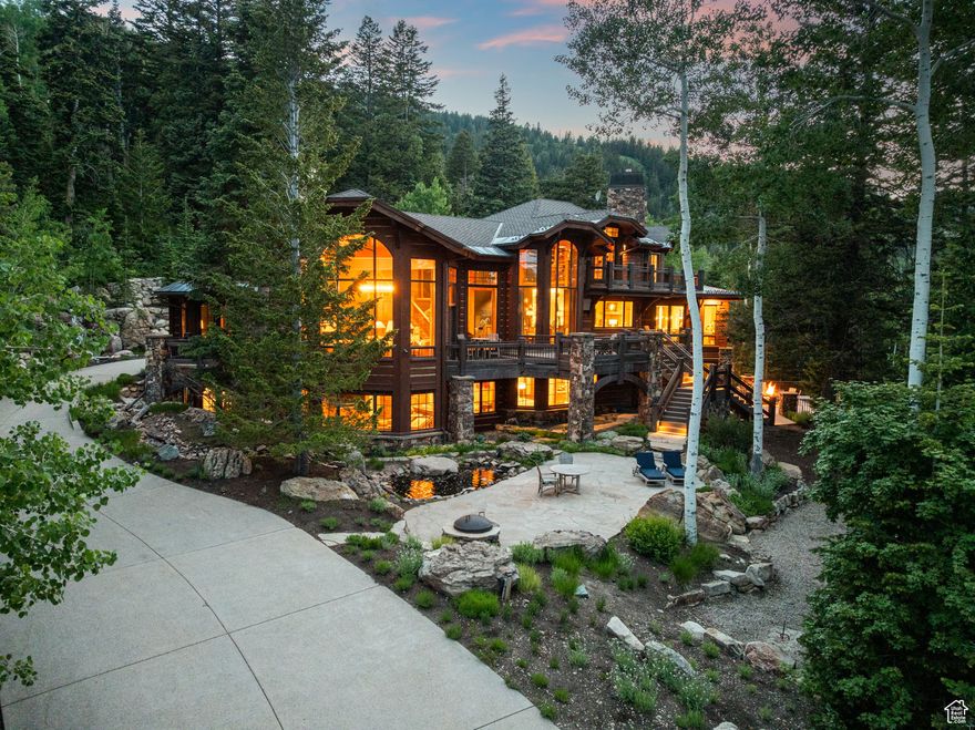 The closest ski-in/ski-out estate to The Colony gatehouse, 22 White Pine Canyon Road offers unrivaled privacy, accessibility, and turnkey mountain luxury in one of Park City's most coveted locations. Designed by the renowned Otto-Walker Architects and set on over five pristine acres at 7,600 feet elevation, this architectural retreat blends timeless alpine elegance with modern sophistication. Just three minutes from The Colony's private entry gate, the property offers exceptional access to town and travel, while still feeling worlds away. A dramatic stone bridge leads to a fully snow-melted driveway, flanked by a cascading waterfall and a serene summer pond. Inside, natural textures and refined finishes unfold across more than 11,000 square feet of living space, recently refreshed and fully furnished by the award-winning Iluminus Group for a modern, inviting, and move-in-ready feel. At the heart of the home is a newly completed chef's kitchen featuring La Cornue and Miele appliances, a walk-through butler's pantry, and informal dining surrounded by forested views. A custom-designed bunk room with six queen beds and a fully integrated ski lounge enhance the home's year-round functionality. Highlights include: Direct ski-in access and board-out convenience to Tombstone, Timberline, and Over & Out lifts Two spacious primary suites, multiple grand family rooms, a private study Custom 20-person stainless steel hot tub with automatic cover 4K home theater, gym with infrared sauna and steam room Cutting-edge Savant automation for lighting, audio, climate, and security Expansive terraces, two fire pits, and a four-bay garage for cars, bikes, and mountain gear Step outside to access a network of hiking, biking, and snowshoeing trails. Or reach Park City's Historic Main Street in just 15 minutes for fine dining, shopping, and arts. Salt Lake City International Airport and private FBOs are just 40 minutes away, ensuring effortless arrival no matter the season. Offering a rare balance of seclusion, style, and convenience, this is more than a luxury home, it is an invitation to live fully immersed in the best of Park City.