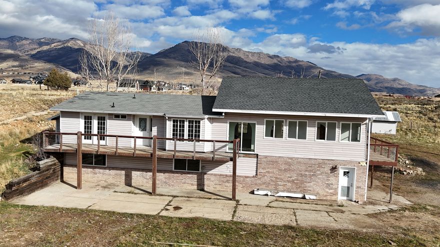 Eden Rambler atop its own mountain ridge with million dollar views!  1.95 acres of land that has a portion fenced if you want animals.  Home has huge, vaulted family room with views from all sides.  Two beds/2 baths on main level, but front family room can be converted to another bedroom if needed.  Basement has an office space (no window), but a fourth bedroom can be created in basement family room area, making this a 4 bed, 3 bath home.  Home needs some work (baths need remodeled and kitchen completed-has new cabinets and flooring/light completed...just needs countertops and appliances.).  Primary shower just tiled.  LVP flooring installed throughout home and new paint.  Two car garage that has an enclosed room in it, that can be removed if you don't need it, making room for more vehicles or shop area.  Property has a quonset hut (30x13x11'center) and shed (10x12).  Deer frequent the home and relax in the yard.  Home sits just east of Nordic Valley Ski, south of Powder Mtn, north of Snowbasin and north of Pineview Reservoir for all your boating, skiing, paddle boarding and fishing you want.  Make this home your own Mountain Villa or turn it into a nightly rental in time for the Utah Olympics (check with local zoning laws first).  See Video Tour for a property flyover.  I have a walk through video of home for those requesting to see it.