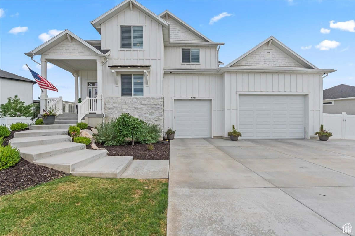 Nestled in South Weber, this clean and spacious home offers 6 bedrooms and 3.5 bathrooms with thoughtful upgrades throughout. The main living area features a shiplap accent wall, custom shutters on every window, and a bright, open kitchen with quartz countertops, double ovens, and plenty of space to entertain. A stylish office with a modern decorative wall provides the perfect work-from-home setup. The laundry room is designed with convenience in mind, featuring built-in laundry baskets and a countertop. The oversized garage is a true standout-painted, heated, with epoxy floors, a mezzanine for storage, and space for up to 4 vehicles. Step outside to a backyard built for gatherings. A large deck spans the entire back of the home, complete with a hot tub, plenty of room for dining, and space to host friends and family. Lastly, home is equipped with a 12.4 kW solar system, providing energy efficiency and long-term savings. With its beautiful yard and mountain setting, this South Weber gem blends comfort, function, and style.