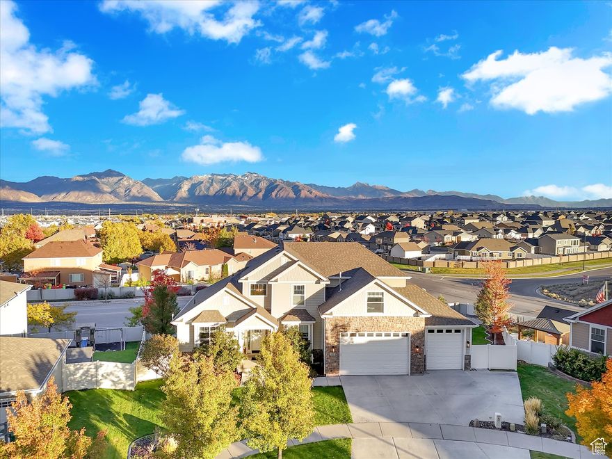 Don't shop new construction when you can have a private mother-in-law apartment already built!!    Spectacular fully finished two-story home in the prestigious Sycamores neighborhood featuring a private 2-bedroom, 1-bath mother-in-law apartment with its own entrance - perfect for multi-generational living, guests, or rental potential. The main home offers a luxurious main-floor primary suite with a spacious walk-in closet, soaring 18-foot ceilings in the living room, and a stunning kitchen with white cabinetry, granite countertops, island, and gas range.  The separate basement apartment is fully equipped with a full kitchen (white cabinets and gas stove), laminate flooring, built-ins, private washer and dryer, and its own furnace and water heater for complete independence and comfort.  Additional highlights include an extra-deep third-car garage with tall doors, abundant storage throughout, and breathtaking valley and mountain views. The backyard is designed for both relaxation and entertaining, featuring a large deck, concrete patio, lighted pathways, dog run, and direct access to the apartment's private entrance.  Ideally located near two parks, just 5 minutes from shopping and only 25 minutes to downtown Salt Lake City and the airport - this home offers space, flexibility, and convenience in one exceptional property.