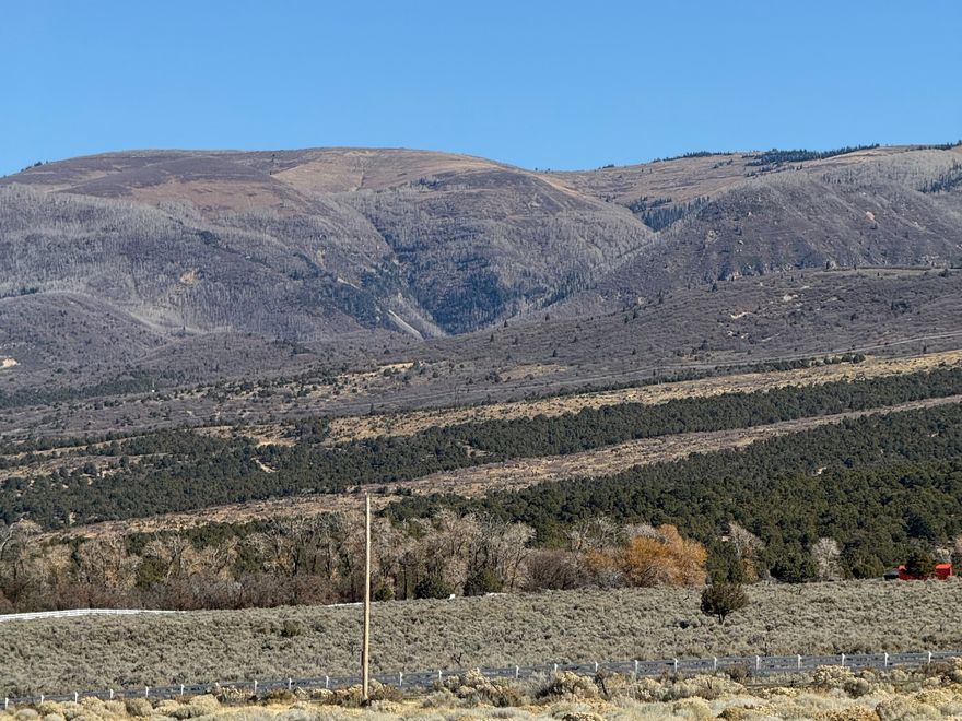 DISCOUNTED FOR A LIMITED TIME!!! If you've been waiting for the perfect lot that's close to the city yet surrounded by stunning mountain scenery, look no further. This exceptional property offers the best of both worlds-easy access to urban convenience and the peace and beauty of nature. With breathtaking views, gently rolling terrain, and plenty of space to build your dream home or getaway, this lot is truly a rare find. The property includes access to a shared well, available for use by up to six neighboring owners. To utilize the well, a water right is required but not included. If you prefer full independence, there's also the option to drill your own private well. Seller Financing options are available. Lot # 1