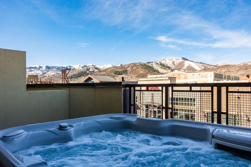 Experience the best of Park City in this beautifully positioned 2-bedroom, 2-bath Newpark Terrace townhome. As one of a rare 20% of units featuring dual-mountain vistas, this home captures unobstructed views of the Utah Olympic Park and Wasatch Mountains to the west, plus the Uinta Mountains and Swaner Nature Preserve to the east. Large sliding glass doors and windows with premium motorized blinds flood the open-concept living area with natural light. The thoughtfully designed layout features two private ensuite bedrooms, including a lower-level suite with direct patio access and pristine Olympic Park views. This tech-forward residence offers universal smart-home compatibility (Amazon, Google, etc.), including a Nest thermostat. Two spacious private patios provide the perfect setting for morning coffee or sunsets after a day in the mountains. For the outdoor enthusiast, the oversized one-car garage is outfitted with an integrated wall-slat system and automated LED lighting. Enjoy an unbeatable location within walking distance to temporary guest parking, trails, the Basin Recreation Center, and Kimball Junction dining, with easy transit access to ski resorts and Historic Main Street. Nightly rentals are permitted and furnishings are available for a true turnkey opportunity.