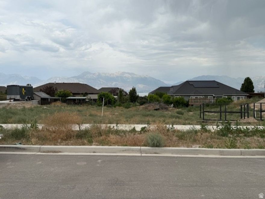 Located in the highly sought-after Jacobs Ranch subdivision, this spacious 0.27-acre lot offers stunning views of the mountains, valley and Utah Lake. With all utilities stubbed and no HOA restrictions, it's the perfect site to create a custom home in a peaceful, established neighborhood. Just minutes from schools, parks, shopping and hiking trails, opportunities like this are rare!