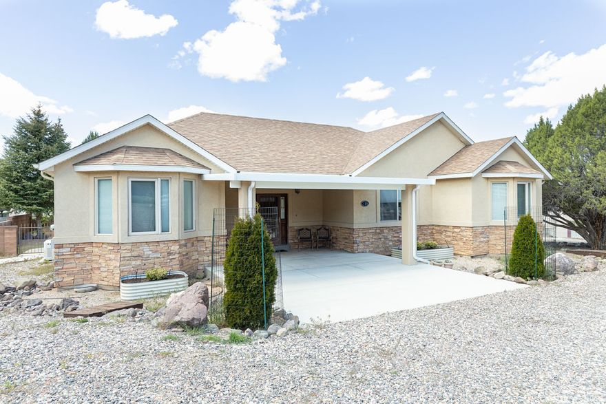 Located in Valley Heights Estates on the east bench near Parowan, this custom 3 bed, 2 bath ranch home sits on 1.06 acres with beautiful mountain views and a quiet, rural setting just minutes from I-15 and outdoor recreation. The 2,100 sq ft single-level layout features hardwood floors, granite countertops, Phelps custom cabinetry, formal dining, and a spacious primary suite. A new gas insert fireplace adds warmth and comfort to the main living area. Major upgrades include a newer roof (approx. 2 years), updated HVAC system with improved return air, and a Generac backup generator with automatic transfer switch. The property offers excellent functionality with RV parking, a 3-car attached garage, and a detached 3+ car shop with its own gas heater-ideal for projects, storage, or equipment. Outdoor features include a covered patio with added awning, drip irrigation with low-point drain, and a fenced yard with secure entry. Quality construction with 2x6 framing and 8" stem walls completes this well-built, well-maintained home in a highly desirable location.