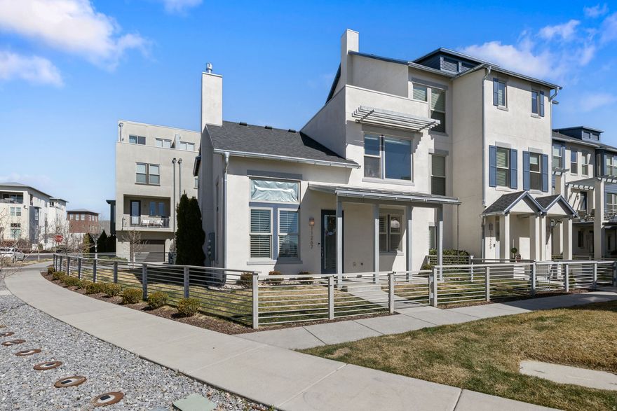 This end unit townhome with main level living and a fenced yard is steps away from Soda Row, Oquirrh Lake, and multiple trails! The great room highlights vaulted ceilings, pristine tile floors, plantation shutters, and stone surround gas log fireplace. Kitchen boasts crisp white cabinets with crown molding, stainless steel appliances, subway tile backsplash, stylish pendant lighting, and gas oven. Spacious master bedroom located on the main floor features walk-in closet and bathroom with generous Euro shower. You'll enjoy the large yard with no mowing or sprinkler maintenance! Additional amenities include stackable laundry hookup closet on main floor and side by side laundry upstairs. Also enjoy the nearby shops, restaurants, farmers market, food truck nights, and other Daybreak amenities including: Community pools, kayaks, splash pad, community gardens, Community Fitness center & more! Great location, great price, stellar condition! This home is a MUST SEE!!