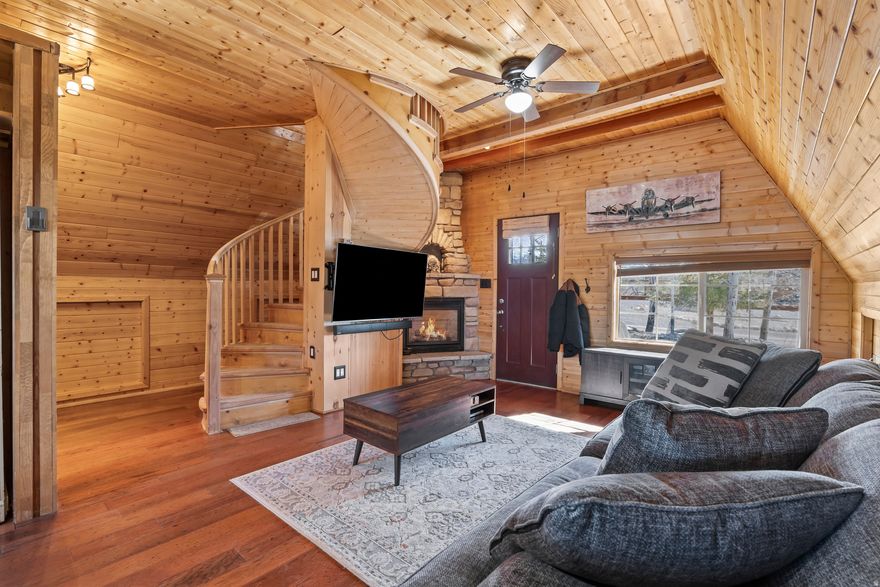 Beautiful cabin located in the gated Skyline Mountain Resort community with year-round access in the plowed portion of the resort. This charming retreat features 2 bedrooms and 1 bathroom and has been remodeled with gorgeous tongue-and-groove finishes. Enjoy the peaceful mountain setting from the large deck overlooking a seasonal stream next to the fire pit area. The second bedroom also features a private balcony. Additional features include an 8x16 storage shed for ATVs and outdoor toys, a bunkroom, open field space for recreation, and a quiet  location for added privacy. Miles of ATV and snowmobile trails run throughout the resort. Utilities include city power and connected water, an owned 500-gallon propane tank fueling the gas fireplace, wall heaters in each room, septic system, water hookups. Landscaping includes a sprinkler system in the covered garden area.   Square footage figures are provided as a courtesy estimate only and were obtained from county records.  Buyer is advised to obtain an independent measurement.