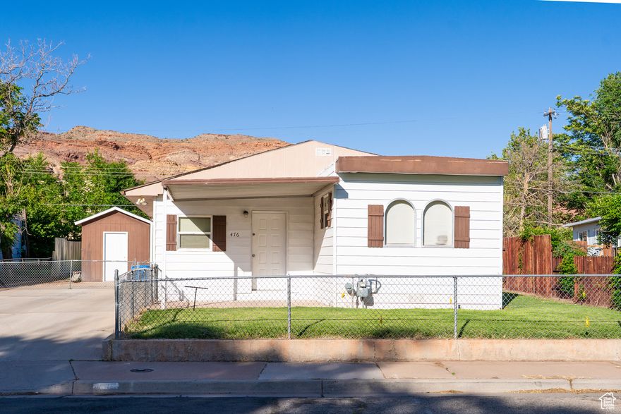 Furnished, move-in ready Moab home with a main 2-bed, 1-bath unit and a separate 1-bed, 1-bath mother-in-law suite, complete with its own entrance and kitchen-perfect for family or guests. Enjoy a large, naturally lit living room, two electric fireplaces, some updated appliances, and a new washer and dryer. You'll love the the outdoor living on the spacious back deck, a fully fenced yard, and a shed for extra storage. The home is walking distance from schools, a park, and the aquatic center. Potential seller financing to a qualified buyer with an acceptable down payment.   Square footage figures are provided as a courtesy estimate only. Buyer is advised to obtain an independent measurement.