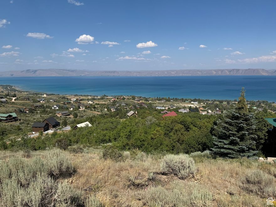 Beautiful lake/mountain VIEWS on .66-acre surveyed building lot with water connection fee paid!  Year round access.  Backs common area.  Bear Lake West amenities: outdoor pool, hot tub, tennis/pickleball courts, beach access.  Coopers Restaurant and Golf Course open to public, with discount for BLW owners.