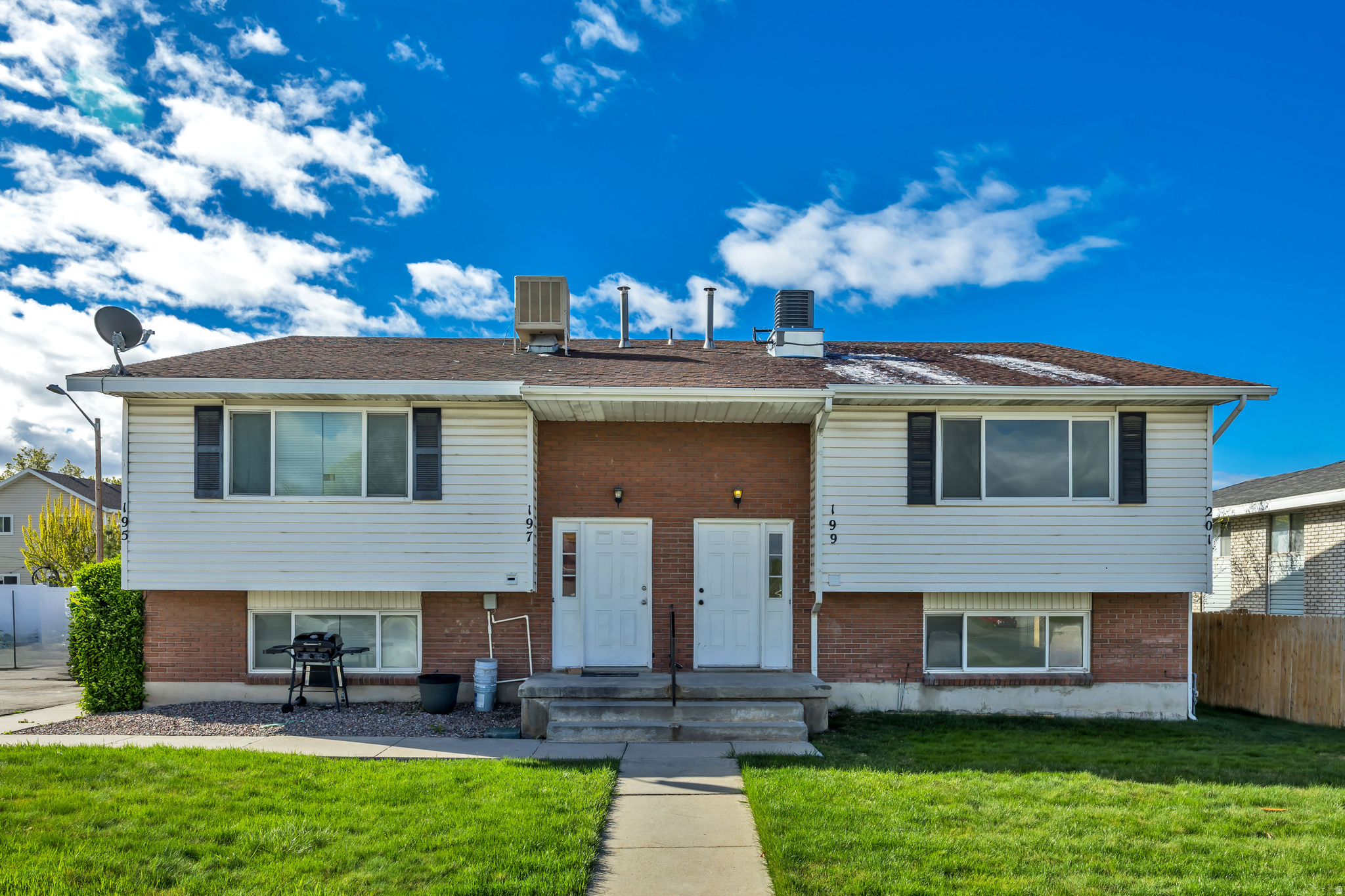 Duplex property featuring brick and siding exterior construction