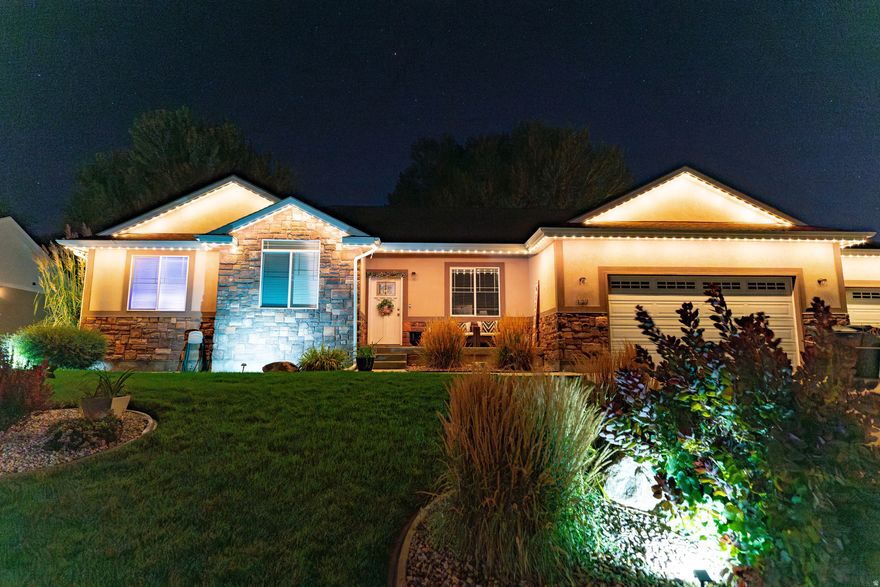 Experience refined living in this stunning 3,500 sq ft luxury residence located in the highly sought-after Westwood neighborhood of Price. Thoughtfully designed with both elegance and functionality in mind, this 4-bedroom, 3 1/2-bathroom home offers exceptional space, premium features, and endless potential.  The interior showcases beautiful flooring, recessed lighting, and a flowing open-concept layout that creates a bright and inviting atmosphere. The chef-inspired kitchen features a generous bar area, perfect for entertaining, hosting gatherings, or enjoying everyday living in style.  Enhancing both curb appeal and ambiance, the home is equipped with Trimlight adjustable outdoor lighting, allowing you to customize the exterior lighting for every season, holiday, or occasion. A fully automated sprinkler system keeps the landscaping pristine and effortless.  The oversized 3-car garage includes an attached workshop room, offering exceptional flexibility for hobbies, storage, or creative space. Downstairs, the unfinished basement presents a rare opportunity to expand-ideal for a luxury theater room, home gym, guest suite, or additional living quarters tailored to your vision.  Set in one of Price's most desirable neighborhoods, this home delivers a perfect balance of luxury, comfort, and future potential. Properties of this caliber and location are rarely available-this is an opportunity not to be missed.