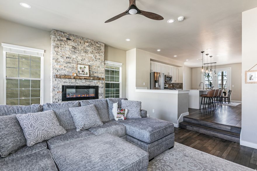 Modern, move-in ready 3-story townhome featuring 4 bedrooms, 3.5 bathrooms, and an attached 2-car garage. Thoughtfully designed with an open layout, large windows, and abundant natural light. The main living area includes a rock fireplace and custom built-ins, flowing into a spacious kitchen with an oversized butler's pantry. Flexible lower-level suite works well as a guest space or office. The primary suite offers high ceilings and a private fireplace. Low-maintenance living with contemporary finishes throughout.