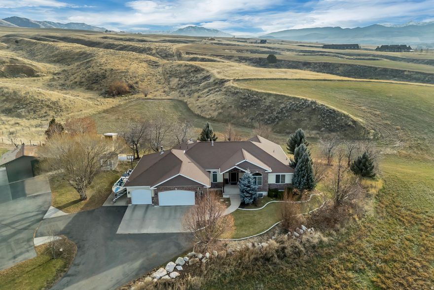 2.45 Acres south of Hyrum with VIEWS and quiet living! A MUST SEE from the front porch to the newly rebuilt and finished back deck.  Fully finished 3,800 sq ft 6 bed, 3 bath home sits just outside of Hyrum, UT. Only 9 Miles south of Logan, UT, 56 miles to Powder Mountain Ski Resort and 83 Miles to SLC Airport. Well designed layout for everyday living and entertaining. Indoor/outdoor living from the great room to the deck and secluded yard. Retreat to the primary suite with your own access to the back yard. Fully finished basement features storage and a large recreation room, and yes it connects to the lower outdoor patio. Basement sound room, fully insulated and electrical in all the right spots to display and create. Room for the toys in the 4 car garage (heated by wood burning stove). 40 foot RV Parking. Disconnected from the city, with Propane for gas, Solar for extra low power bills and your own water (well is shared with neighbor to the east). Come for the views and stay for the views, can not be understated. Call or Text to schedule your tour, qualified Buyers only.