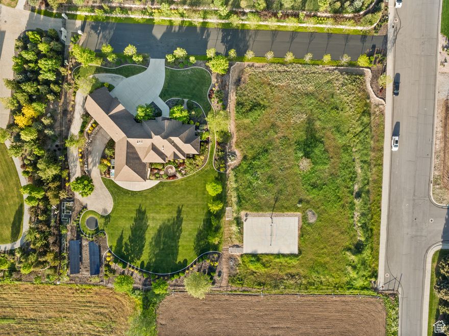Stunning custom rambler on 2 acres with panoramic views of Utah Lake, Maple Mountain, and Mt. Nebo. Over 6,000 sq ft of luxury living with main-level primary suite, office, great room, and zero-step entry-true ADA accessibility. Soaring 1013' ceilings, expansive windows, and Control4 smart home system. Gourmet kitchen features Wolf 60" range, Sub-Zero fridge, hidden pantry, slab island, and custom cabinetry. Walkout basement boasts rec room, fireplace, surround sound, and guest suite. Finished 3-car garage + shop with hanging slab. Solar (42 panels), whole-house audio, security, and water filtration systems. Backyard retreat includes pickleball/basketball court, in-ground trampoline, hot tub and mature trees. Lot has the possibility to be subdivided.  Too many upgrades to list-this is a must-see masterpiece!