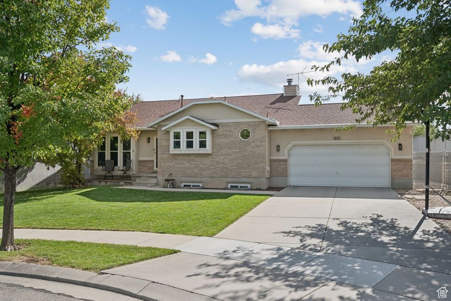 Tucked away on a quiet South Jordan cul-de-sac, this beautifully updated home is much larger than it appears from the outside. The open layout features vaulted ceilings, newer flooring, and a bright, spacious family room with surround sound, perfect for relaxing or entertaining. The kitchen and dining area flow seamlessly into a cozy nook with a built-in bookshelf and moving ladder, adding warmth and character. Enjoy thoughtful updates throughout, including a brand new roof, water heater, and fridge (September 2025). The unfinished sixth bedroom and generous storage offer flexibility for your needs. Outside, the covered patio overlooks a well-maintained yard with a full sprinkler system and peaceful canal views. With irrigation water and plenty of space to spread out, this home combines comfort, privacy, and everyday convenience.