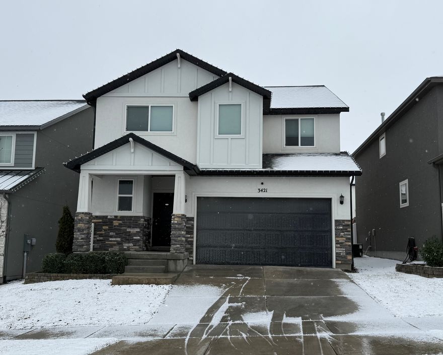 Beautifully upgraded and meticulously maintained, this 2020 Herriman home is truly better than new.  The main level features a tastefully designed kitchen with custom cabinetry, large island, designer lighting, upgraded backsplash, and exposed wood beams that add warmth and character. The living area includes a fireplace with built-ins, creating the perfect gathering space. The main-level mudroom is also upgraded with custom finishes, adding both style and function.  The fully finished basement includes a stylish wet bar, and a cozy TV area with a second fireplace - ideal for entertaining or relaxing. Bathrooms showcase modern tile work and quality finishes, including a spa-like primary bath with soaking tub and separate shower. Enjoy a professionally finished backyard with paver patio, fire pit area, and full vinyl fencing. The garage features an epoxy floor and built-in storage.  Located at a desirable Herriman neighborhood, just minutes from Mountain View Corridor, I-15, shopping, dining, parks, trails, and great schools.