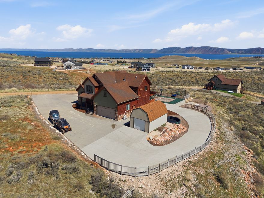 This property has been used as a family retreat and has also been a very successful rental in the vacation rental pool for many years. It is in immaculate condition and has been regarded as one of the premier vacation rentals in all of Bear Lake. It comes with a built in clientele if wanted. It is a resort all by itself. It has a sport court, gaga pit, fire pit, ping pong table, pool table, and parking for many boats, cars and side by sides. The property includes access to all Ideal Beach amenities for a fee. The property includes a superb surround sound system with a 100 inch TV for cinematic viewing. Also includes parcel 36-05-150-0073