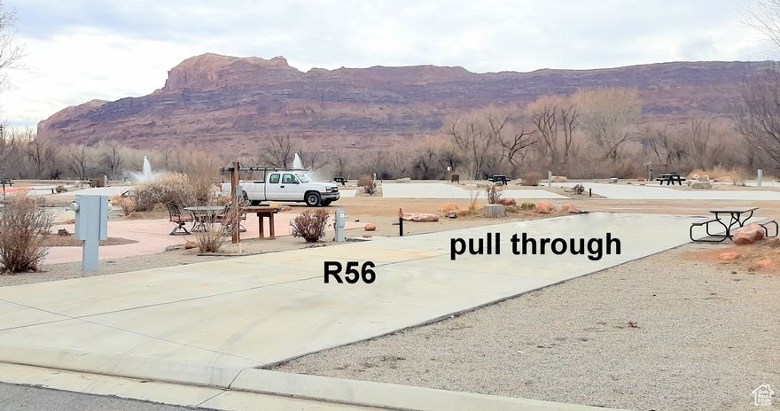 Own a piece of the Rock! Or just enjoy owning this nightly RV rental investment spot at the Portal RV Resort by Roberts Resorts has rebranded to Village Camp Moab. Yes, it is a pull through lot for easy parking and easy hook ups. This large concrete pad 87' long x 20' wide fits your extra large RV and a casita can be built in this area and still have room for your motor home, A graveled area 18' wide x 22' deep side space is a great place to park your tow behind vehicle or visitor parking. Rubicon Trail 56 is located close to the pool, hot tub, pickle ball court, the pond, laundry service area, men's & ladies bathrooms, the exercise gym and the pathway to the dog park. Enjoy views of to the western views of the Colorado River's famous Portal, southeast, views of the La Sal Mountains, eastern and west views of the Red Rock walls of Moab and the views of the Portal Pond. There are open areas with paths leading to seating areas that take in the views and or are a great place to read a book. When you are not in town, The management of this park can rent out your investment property for you.  This is an easy, carefree investment, securing a place to park your RV when in the Moab area. Acreage figures are provided as a courtesy estimate only and were obtained from county records. Buyer is advised to obtain an independent survey measurement. The fees include basic cable, pool and grounds maintenance. http://www.portalrvresort.com/rules---regulations.html