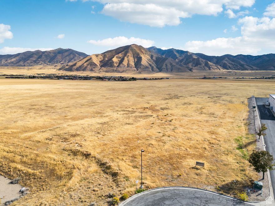 Discover the perfect blend of opportunity with this 17.22-acre property in the heart of Tooele. The front portion is zoned commercial, ideal for retail, dining, or office space, while the back is zoned research and development but city plans outline medium density residential, perfect for townhomes, apartments, or a vibrant new neighborhood.  Surrounded by exciting new developments and offering stunning mountain views, this property is positioned for incredible growth. With dual zoning and a prime location, it's ready for a visionary buyer to create a dynamic, mixed-use destination.