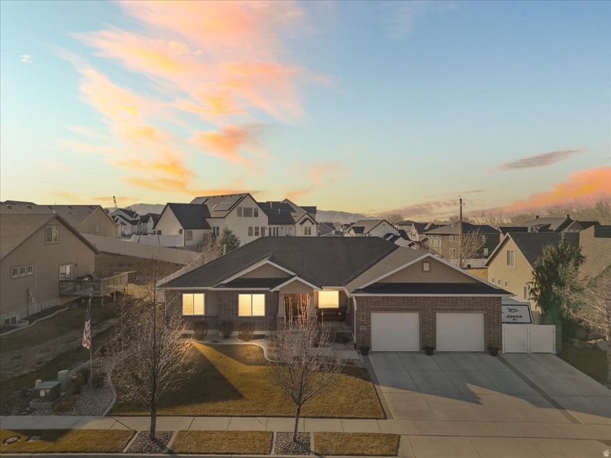 Stunning Custom Rambler in Highly Desirable Spanish Fork Location! If you're looking for a home with custom finishes throughout, this is your home! Discover this beautiful 5-bedroom, 3.5-bath custom rambler nestled in one of Spanish Fork's most sought-after neighborhoods! Enjoy being just a short walk to the Spanish Fork River Trail, Spanish Fork Sports Park, and the brand-new Spanish Fork Fit City Center. Step into the heart of the home - a gourmet kitchen featuring exquisite custom cabinetry, granite countertops, a spacious island, and a hidden pantry. Under-cabinet lighting creates the perfect ambiance for cooking and entertaining. Both upstairs and downstairs include custom built-in entertainment centers, ideal for cozy movie nights and large family gatherings. The owner's suite is truly a retreat, with beautiful built-ins, a large walk-in custom closet, double vanity, custom tile shower, and a relaxing garden tub - the perfect place to unwind after a long day. Head downstairs to a fully finished basement complete with a large family room, kitchenette, and plenty of storage. Outside, you'll find exceptional curb appeal with upscale landscaping, a serene water feature, a large covered deck, and a private patio - perfect for enjoying summer evenings. The oversized garage and RV parking provide all the space you need for vehicles and toys alike. With a custom lighting package inside and out and speaker pre wire in the basement, every detail has been thoughtfully designed. This immaculate home feels brand new and is ready for you to make it your own! Come see this one-of-a-kind property today - you won't be disappointed! Square footage figures are provided as a courtesy estimate only and were obtained from Utah County records. Buyer is advised to obtain an independent measurement.