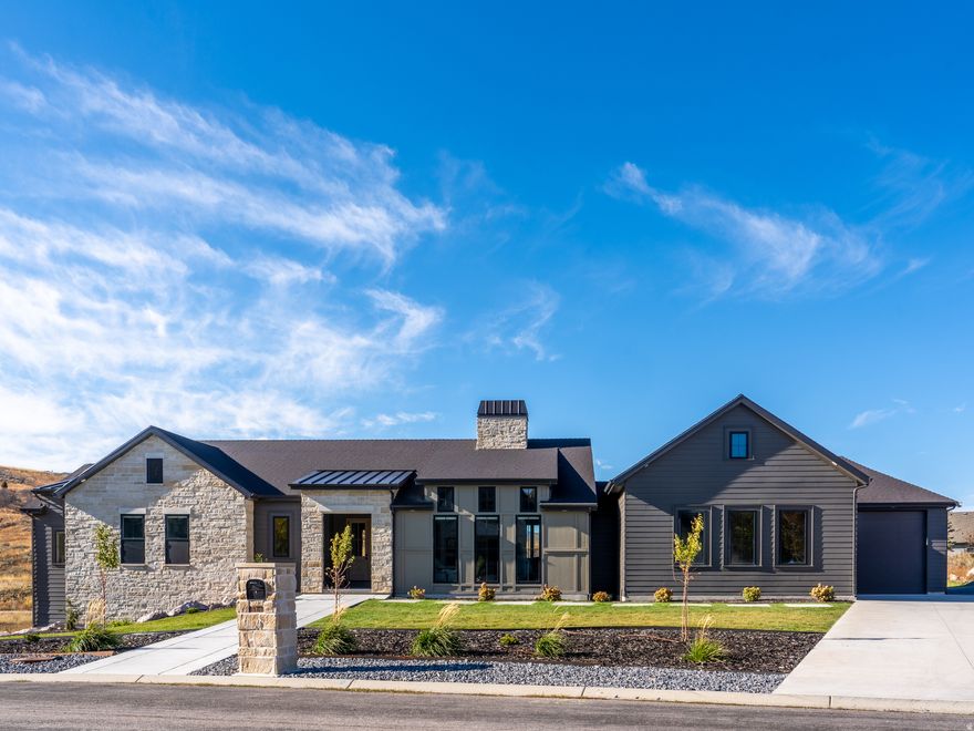 Welcome to this exceptional home combining modern design with timeless comfort. Perfectly situated on nearly half an acre, this 5,335 sq. ft. residence offers luxury living with panoramic hillside views and thoughtful craftsmanship throughout. Step inside to discover an open-concept floor plan featuring vaulted ceilings and an abundance of natural light. The centerpiece of the great room is a striking double-sided stone fireplace, creating warmth and ambiance for both the living area and the kitchen. The chef's kitchen is a true showpiece, boasting a large marble island, premium stainless-steel appliances, custom cabinetry, and elegant pendant lighting. Expansive windows frame the serene natural surroundings, while the adjoining dining area opens seamlessly to a covered patio - ideal for year-round entertaining. The spacious primary suite provides a peaceful retreat with spa-inspired amenities and ample closet space. Seven additional bedrooms offer incredible flexibility for family, guests, home offices, or a fitness studio. Enjoy the perfect blend of indoor-outdoor living with a covered deck overlooking the landscaped yard, surrounded by scenic rolling hills. A 5-car garage, ample storage, and refined finishes throughout complete this remarkable property. Located in a desirable neighborhood, this home offers privacy, elegance, and the perfect setting for modern living. All property information, boundaries and documents to be verified by buyer.