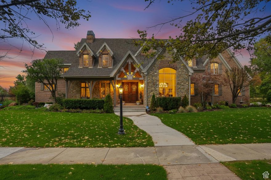 Nestled on one of Draper's most enchanting tree-lined canopy streets, this extraordinary estate sits on a private 0.61-acre lot-the crown jewel of the neighborhood. The hand-crafted brick and real stone exterior, solid Brazilian cherry wood flooring, Marvin wood-clad windows, and exquisite architectural details exemplify timeless, curated craftsmanship. The open-concept design features a two-story great room with a 30-foot real stone fireplace and wood-beamed ceiling. The gourmet kitchen offers informal dining, granite countertops, a new Thermador range, hood, and oven, plus a walk-through butler's pantry leading to a formal dining room. A spacious theater room on the lower level adjoins a kitchen, ideal for entertaining. The home offers unmatched flexibility with seven bedrooms, including four en-suite baths, two main-floor powder baths, three family rooms, a large craft/wrapping room, three storage rooms, and a private multi-desk office with built-ins. The main-level primary suite features an en-suite bath, a large walk-in closet with built-ins, and an island with locking jewelry drawers. French doors open to private, shaded outdoor dining and a serene backyard with a spa-like retreat. Additional features include solid wood four-inch shutters, three fireplaces, three air conditioners, and four furnaces that maintain consistent temperatures, an ADT security system, and nine-foot basement ceilings. The heated four-car garage includes two EV outlet plugs. Six French doors open to the backyard, allowing you to enjoy seamless indoor-outdoor living. Main-floor and lower-level laundry rooms offer added convenience. The backyard provides privacy with an eleven-foot-deep saltwater pool, a peaceful babbling stream, and shaded dining under a pergola with views of a five-acre ranch filled with horses and wildlife. Two water shares offer secondary water to complete this exceptional property. This estate offers a lifestyle of elegance, comfort, and natural beauty in one of Draper's most coveted neighborhoods.. Square footage figures are provided as a courtesy estimate only and were obtained from County Records.  Buyer is advised to obtain an independent measurement.