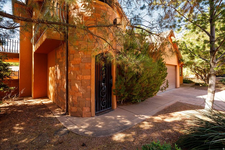 This beautiful home is set against the dramatic red cliffs and designed for both elegance and comfort. It has a bonus ADU/Casita as well. The homes inviting entry opens to a refined interior featuring formal living area with a fireplace, 3 bedrooms and 2.5 baths. A formal dining room with bay windows leads into the well-equipped kitchen, complete with abundant storage, newer appliances, and a pantry. The laundry room includes an upgraded washer and dryer with small-batch drawer for added convenience. Upstairs, the spacious primary suite offers a cozy fireplace, ensuite bath, and balconies with breathtaking views. An additional bedroom, full bath, and a versatile family/exercise room complete the second level. A highlight of this property is the private ADU/Casita with its own entrance, kitchenette/studio space, and  bath-perfect for guests, extended family, or income potential. Located in La Estancia, a premier subdivision known for its community amenities and unmatched setting at the mouth of the red rocks, this home blends style, function, and lifestyle in one. Community Amenities are amazing home is near the pool. Call for your private tour. Buyer to verify all details.
