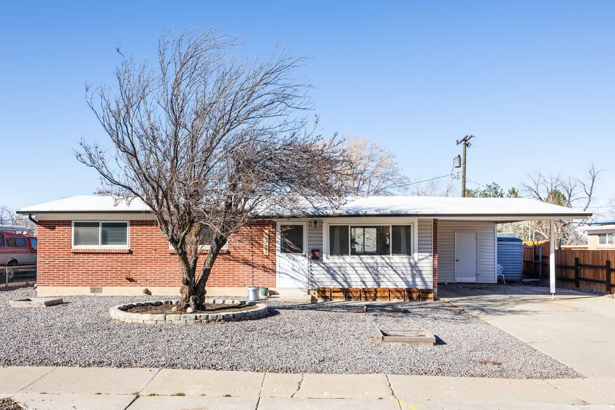 This cozy, move-in-ready ranch-style home offers thoughtfully updated living space and the perfect amount of square footage for first-time home owners or someone seeking low-maintenance living. Built in 1961, it's been well cared for and fully updated, so the major expenses have already been taken care of here. The open, remodeled kitchen features a functional layout and updated appliances, including a new range, dishwasher, and microwave installed in 2017, plus a new refrigerator added in 2024. The property offers comfortable, efficient living with a practical floor plan and a single-vehicle carport (ideal for winter parking). Plumbing, electrical, and A/C were also updated in 2017, a new water heater was installed in 2023, and the washer/dryer were replaced in 2024 (in other words, peace of mind). Outside, xeriscaping was completed in 2021, making both the front and back yards attractive, low-water outdoor spaces to enjoy as long as the weather allows. This home also sits on an established, tree-lined street, adding to its charm and creating a sense of community. Bonus: residents here will be within walking distance of Dimple Dell Regional Park, which means easy access to scenic hiking and biking trails, or some incredible bird watching, if that's your thing. All told, this is a home that's both peaceful and practical, making it your next best decision for 2026.