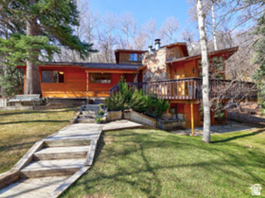 LOCATION, LOCATION, LOCATION! This mountain home is a rare find; one of the closest homes to the Sundance ski village. Whether you're dreaming of a 5-minute walk to the ski slopes with no crazy traffic, enjoying cool and peaceful summer evenings in the pines, or you want a smart investment that can pay for itself in rental income, you've found it!  This home brings the rustic character, comfort, and convenience that make Sundance feel like the mountain home you've always wanted. Perfectly located on a sun-filled, neighborhood road with very easy year-round access and lots of usable yard space, this property also boasts a flat driveway with parking for up to 7 vehicles and a large, beautiful yard. You and your family will enjoy the easy stroll down to the resort village to participate in its many activities, and you'll love the private outdoor dining this home has to offer, for large or small groups, with a very spacious deck surrounded by pines, maples and aspens. There's plenty of seating and dining space, plus room for a hot tub. Inside the main living area are soaring vaulted ceilings, floor-to-ceiling windows that pour in the natural light, a crackling, wood-burning fireplace, and an open, airy layout; perfect for entertaining. Five bedrooms and four baths give everyone their own space, while the daylight, walk-out basement with a wall of windows and wood burning fireplace is ready for game and movie nights. All furnishings come with the house except a few special art pieces and personal items. Square footage figures are provided as a courtesy estimate only and were obtained from appraisal.  Buyer is advised to obtain an independent measurement.