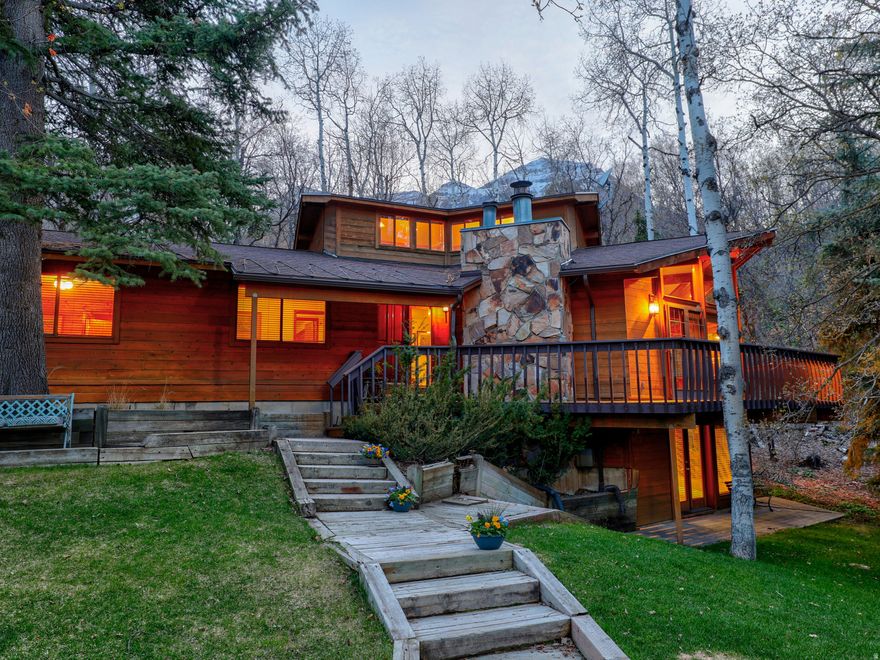 LOCATION, LOCATION, LOCATION! This mountain home is a rare find; one of the closest homes to the Sundance ski village. Whether you're dreaming of a 5-minute walk to the ski slopes with no crazy traffic, enjoying cool and peaceful summer evenings in the pines, or you want a smart investment that can pay for itself in rental income, you've found it!  This home brings the rustic character, comfort, and convenience that make Sundance feel like the mountain home you've always wanted. Perfectly located on a sun-filled, neighborhood road with very easy year-round access and lots of usable yard space, this property also boasts a flat driveway with parking for up to 7 vehicles and a large, beautiful yard. You and your family will enjoy the easy stroll down to the resort village to participate in its many activities, and you'll love the private outdoor dining this home has to offer, for large or small groups, with a very spacious deck surrounded by pines, maples and aspens. There's plenty of seating and dining space, plus room for a hot tub. Inside the main living area are soaring vaulted ceilings, floor-to-ceiling windows that pour in the natural light, a crackling, wood-burning fireplace, and an open, airy layout; perfect for entertaining. Five bedrooms and four baths give everyone their own space, while the daylight, walk-out basement with a wall of windows and wood burning fireplace is ready for game and movie nights. All furnishings come with the house except a few special art pieces and personal items. Square footage figures are provided as a courtesy estimate only and were obtained from appraisal.  Buyer is advised to obtain an independent measurement.