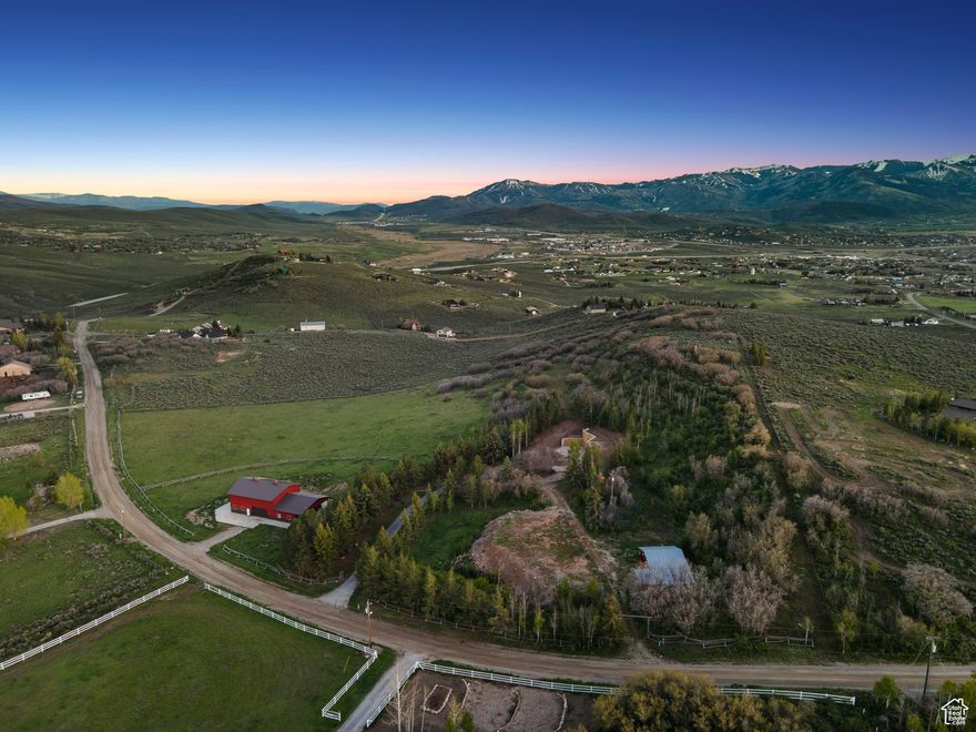 A premier 12.48-acre land offering in Silver Creek Estates with sweeping mountain views, full rail-and-post fencing, a roper barn, and run-in shed. Former home removed-now a clean, build-ready canvas with multiple estate sites, gentle terrain, and easy access to Park City, Kimball Junction, and year-round recreation