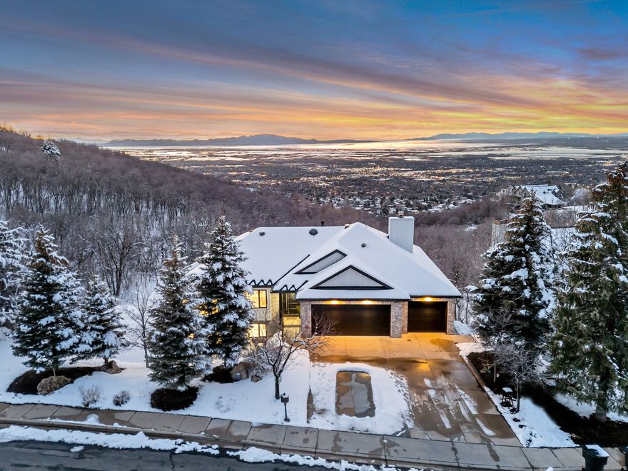 GRAND OPEN HOUSE SATURDAY MARCH 28TH 12PM-3PM!  A Masterpiece for the Discerning Perfectionist! This isn't a typical listing-it's an invitation to acquire a once-in-a-lifetime architectural work of art. The owner, a builder and perfectionist, spent four years pursuing absolute quality, and seeks a buyer who values true craftsmanship over "by-the-numbers" appraisals. Perched on Bountiful's prestigious East Bench, the home commands unobstructed valley and Great Salt Lake views from a quiet cul-de-sac-offering privacy, safety, and a serene setting. Nestled against the mountains, with water resting at its feet-this home sits in the valley between two peaks, positioned in the classic feng shui form of "leaning against the hill, facing the water." It's a setting where prosperity settles in and grows"-the kind of place that just feels right.  Despite this peaceful retreat, downtown Salt Lake City is 15 minutes away, the airport under 20, and amenities just 510 minutes. World-class skiing at Park City is a 40-minute drive, with two top-ranked public golf courses within two miles. Architectural Highlights: Commercial-grade construction: cement board siding, brand new roofing, and a 2,000+ sq. ft. view deck with crystal glass and stainless steel railings * Italian stainless steel entry door-a bold, sculptural first impression * Solid oak millwork throughout, plus commercial-grade soffits, fascia, and gutters* Sculptural interior staircase with frosted crystal glass treads on a steel structure * High-performance aluminum windows and doors with integrated blind technology-blinds sealed permanently between glass panes, powered by solar panels on frames for zero-maintenance operation; bifolding doors in living areas dissolve indoor-outdoor boundaries *  Hand-smoothed walls and ceilings-a hallmark of true high-end construction * Gourmet kitchen with natural crystal stone island (motion-activated illumination), custom marble backsplash, and FOTILE touchless range hood * Bathrooms clad in large-format marble slabs with honed marble floors, custom low-iron glass shower doors featuring precision soft-closing systems for silent, smooth operation, and anti-fog mirrors *  New HVAC, plumbing, electrical, plus designer garage door and epoxy garage floor with marble baseboards * This is not merely a home-it is a legacy of beauty and uncompromising execution.   Square footage figures are provided as a courtesy estimate only and were obtained from a prior listing. Buyer is advised to obtain an independent measurement.