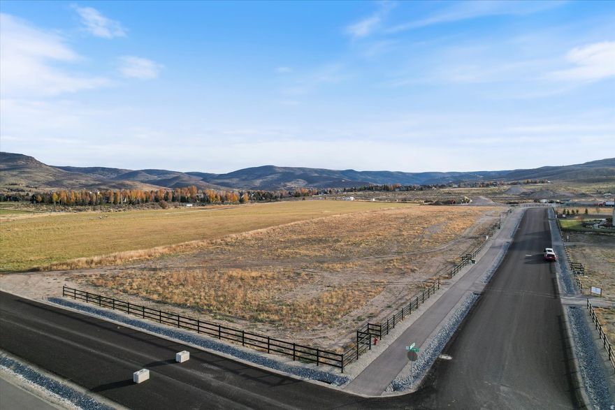 Nestled in the prestigious Meadow View Custom Estate Community of Heber City, Utah, this premium 1-acre corner property offers an extraordinary opportunity to build your dream mountain home-custom designed, curated, and built by The Ashtin Group, a distinguished luxury design-build firm established in 2005 and celebrated for its timeless architecture, refined craftsmanship, and elevated interiors. The planned home encompasses approximately 6,630 livable square feet, including a beautifully integrated guest house, with the option to add an additional 500 square feet of living space above the garages if desired. Architectural elevations and preliminary floor plans have already been completed and are ready to submit for HOA approval, saving you months of design and preparation time. Alternatively, The Ashtin Group's in-house interior design team and expert architectural partners can collaborate with you to create a fully custom home tailored to your family's lifestyle, aesthetic, and vision.  Framed by breathtaking views of Mt. Timpanogos, the Wasatch Range, and Deer Valley, this corner lot captures the essence of refined mountain living. Perfectly situated just 31 minutes from Park City Mountain Resort, and just over 20 minutes to both Deer Valley's Jordanelle Express Lift access in Mayflower and Sundance Mountain Resort, this location offers easy access to Utah's most celebrated ski destinations. In warmer months, enjoy boating, paddleboarding, and fishing on nearby Deer Creek and Jordanelle Reservoirs, along with Blue Ribbon fly fishing on the scenic Provo River and miles of mountain biking and hiking trails.  Ideally located just over 50 minutes from Salt Lake City and just over 30 minutes from Provo, this property combines the serenity of mountain living with convenient access to world-class recreation and modern amenities. Experience the pinnacle of luxury mountain life-where architecture, interior design, and craftsmanship come together seamlessly with The Ashtin Group.