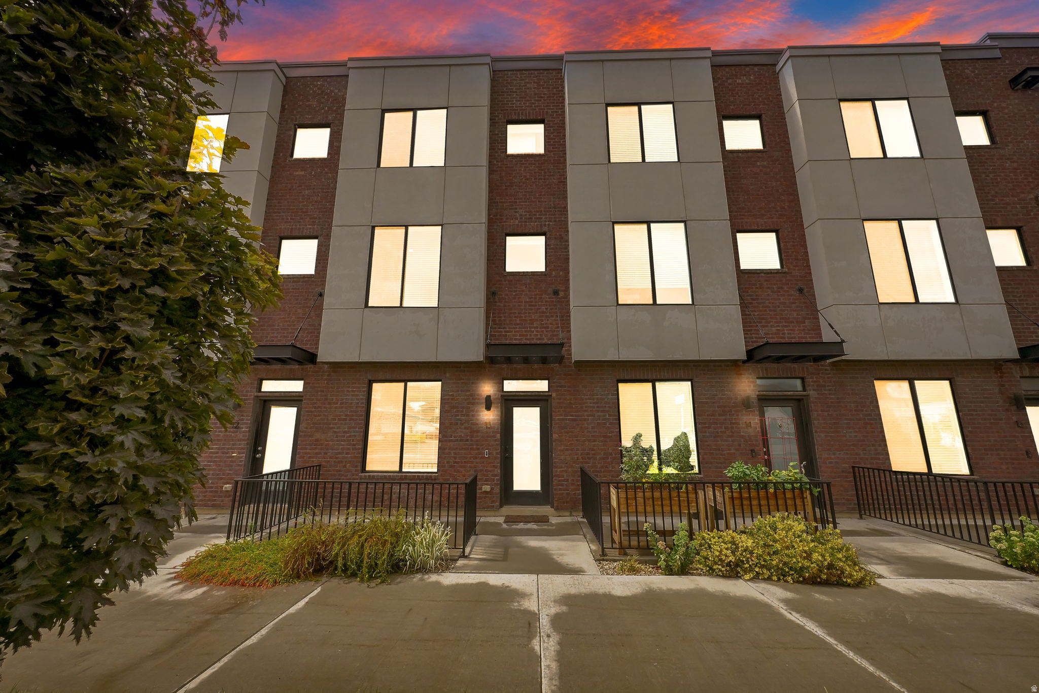 Brick exterior with modern paneling, multiple windows, and a structured entryway