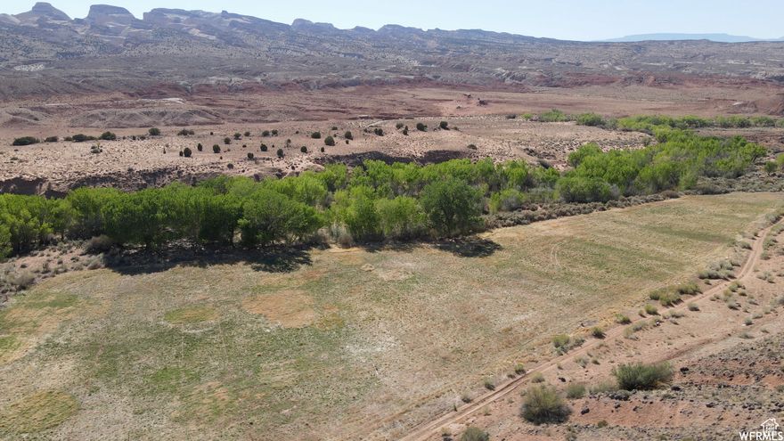 Welcome to this stunning 37-acre oasis nestled in the heart of the desert. Bordering Capitol Reef National Park, this piece of land is an ideal location for agriculture, farming and a host of other potential income opportunities. Boasting a prime location with the park's border, the land provides access to miles of hiking and exploring in the great outdoors. With plenty of room for growing crops and cultivating a thriving farm, this property is perfect for those seeking a peaceful and self-sufficient lifestyle. Additionally, the vast and serene landscape provides a tranquil retreat from the hustle and bustle of city life. The possibilities are endless for this slice of paradise, and it is waiting for you to bring your dreams to life. Don't miss out on this rare opportunity to own a piece of heaven on earth.