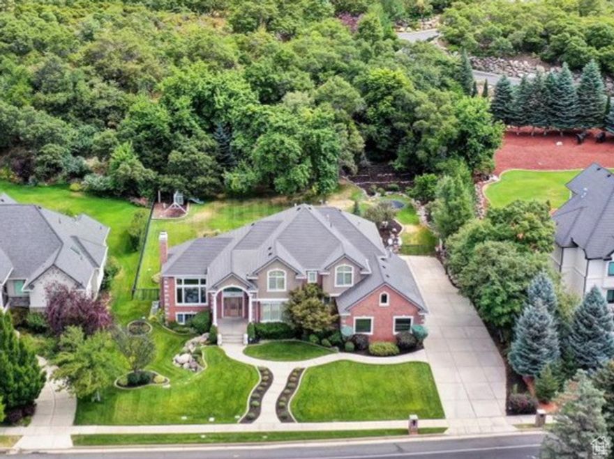 Discover timeless elegance in this beautifully designed home on Skyline Parkway, offering sweeping mountain and valley views from nearly every room. The open floor plan is enhanced by soaring ceilings, custom arches, and designer finishes throughout. The gourmet kitchen features stainless steel appliances, double ovens, and a gas cooktop, perfect for both everyday living and entertaining. A dramatic curved staircase creates a stunning focal point, while expansive windows fill the home with natural light. The spacious owners suite boasts a luxurious bath and a private balcony for serene morning views.  The basement offers 9-foot ceilings, surround sound wiring, and dual furnaces, Outside, enjoy a beautifully landscaped, park-like backyard ideal for relaxing or hosting gatherings. Impeccably maintained inside and out-this Skyline Parkway gem is move-in ready. Square footage figures are provided as a courtesy estimate only and were obtained from County records.  Buyer is advised to obtain an independent measurement.
