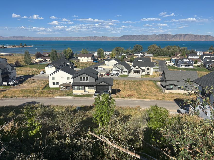 Beautiful Bear Lake building lot in the Lochwood subdivision, in the heart of Garden City. SHORT TERM RENTALS ALLOWED! Popular rental area! Top row of the community, giving you beautiful Bear Lake views. Lochwood amenities include outdoor pool and hot tub, club house with workout room and game area, playground, snow removal, front yard and road maintenance, and water usage included. Perfect spot for your dream home, vacation get-a-way, or a high-yielding investment property. Paved roads with easy year-round access. Sits only 1 minute from the expanded marina, Garden City bike paths, new grocery and hardware stores, and close to restaurants and shopping! Utilities stubbed. Call today before it's gone! Nearby lot also available (lots 85 and 87 available).