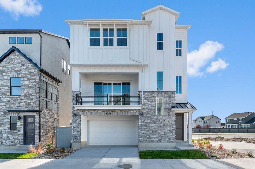 This stunning Whistler Farmhouse style home is located in a sought after Lehi community near schools, parks and Thanksgiving Point amenities.  Enjoy beautiful laminate hardwood, tile, and carpet flooring throughout. Also includes Christmas light outlets, tankless water heater, can lighting and energy-efficient options for modern living. The modern kitchen features Cotton Maple cabinets, quartz countertops, tile backsplash and platinum gas appliances.  Additional highlights include a gas log fireplace, wood railing at the stairway, 2-tone paint, Craftsman base & casing, and an owner's bathroom with quartz shower surrounds and satin & brushed nickel hardware. Comes fully landscaped that is maintained by the HOA for easy care living!