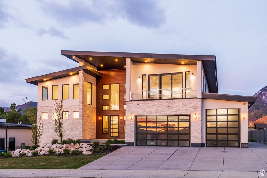 Nestled at the base of Little Cottonwood Canyon with unobstructed mountain views. Only a 15-minute drive to world-class Alta/Snowbird Ski Resorts. Experience unparalleled luxury with this stunning 6-bedroom, 6-bathroom home featuring 23-foot ceilings in the living room, a four-car garage with epoxy floors, and RV parking. The main level showcases a gourmet kitchen with translucent quartzite countertops, a Subzero fridge, Wolf appliances, and a butler's kitchen. The primary suite on the main level includes a fireplace, an oversized walk-in closet, and a marble master bath with dual sinks and showerheads. The basement features a theater room, a large recreational room, a kitchen, and two bedrooms with walk-in closets (one with a private bathroom). The second floor includes 3 bedrooms, a large loft, and two patios, one with city views and the other facing the mountains. This home is a true gem. Call today to book a tour and see it for yourself! All information provided is deemed reliable but not guaranteed. Buyer and buyer's agent to verify all details.