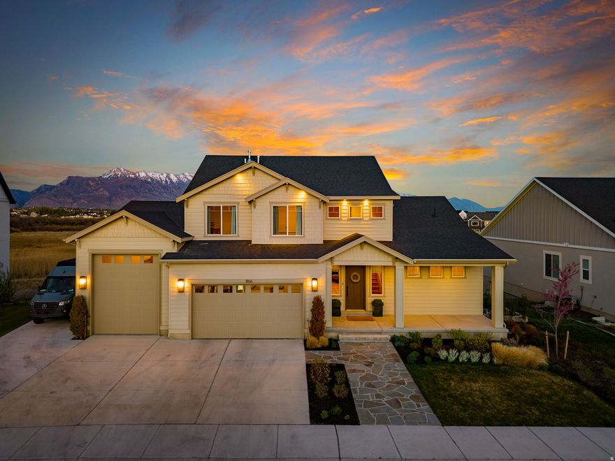 An incredible opportunity to own one of the last unobstructed open views in Utah County. This exceptional 6-bedroom, 3.5-bathroom home with an RV garage is truly unmatched in location, thoughtful interior design, and meaningful upgrades throughout. Perfectly positioned with an east-facing backyard bordered by protected wetlands, this home offers lasting privacy, uninterrupted space, and breathtaking views of Mount Timpanogos. The sunrises here are unforgettable.  Designed for both beauty and function, the home features a large upper deck, covered patio, outdoor shower, theater room, dedicated workout room, and expansive windows that flood the interior with natural light. Premium materials include marble, granite, quartz, natural stone, fine wood finishes, and upgraded carpet selections, all curated with an elevated yet grounded design sensibility. Additional comforts include automated blinds, whole-home humidification, and laundry conveniently located in the primary suite.  Located in a quiet neighborhood near the Jordan River Trail, residents enjoy easy access to walking paths, boat access, parks, pickleball courts, Terra Park, a pump track, and more. This is a rare home that pairs extraordinary views with lifestyle, craftsmanship, and everyday ease.