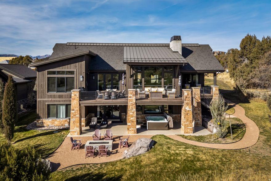 Situated on a quiet road in the coveted Red Ledges community, this beautifully updated 6,200 sq ft mountain-contemporary home offers 5 bedrooms, 6 bathrooms, and exceptional privacy with open space and golf course frontage. Thoughtful recent upgrades, immaculate landscaping, and striking Uinta Mountain views make this property truly move-in ready.  The main level features an open, light-filled layout with large view windows, vaulted ceilings, and upgraded lighting throughout. The spacious great room includes a newly redesigned stone fireplace and seamless connection to the outdoor living areas. The homes east-facing patio and backyard provide comfortable, usable outdoor space all afternoon and evening avoiding the harsh western sun while capturing soft mountain light and cooling breezes.  The chefs kitchen offers farmhouse-style lighting and hardware, along with an added water filtration system. The dining area has been refreshed with new drywall, updated fixtures, and custom window treatments.  The lower level has been extensively improved with new hardwood flooring, a new glass shower enclosure, and upgraded bedroom configurations. Multiple living areas offer flexible spaces for entertainment, relaxation, and guest accommodations.  Exterior and mechanical enhancements include new stonework replacing old concrete, newly installed 220V service for the brand-new hot tub and saltwater spa, upgraded sprinkler components, deck and railing repairs, concrete patio coating, a new radon mitigation system, custom window screens, added exterior dimmers, and a full suite of security features, including multiple exterior cameras. Additional mechanical upgrades include a new water heater and water softener, a new forced-air humidifier system, serviced furnaces and AC units, and upgraded internet/WiFi technology.  Membership to the Red Ledges Club is required, and this home offers the option of a Golf, Golf Park, or Lifestyle Membership available.