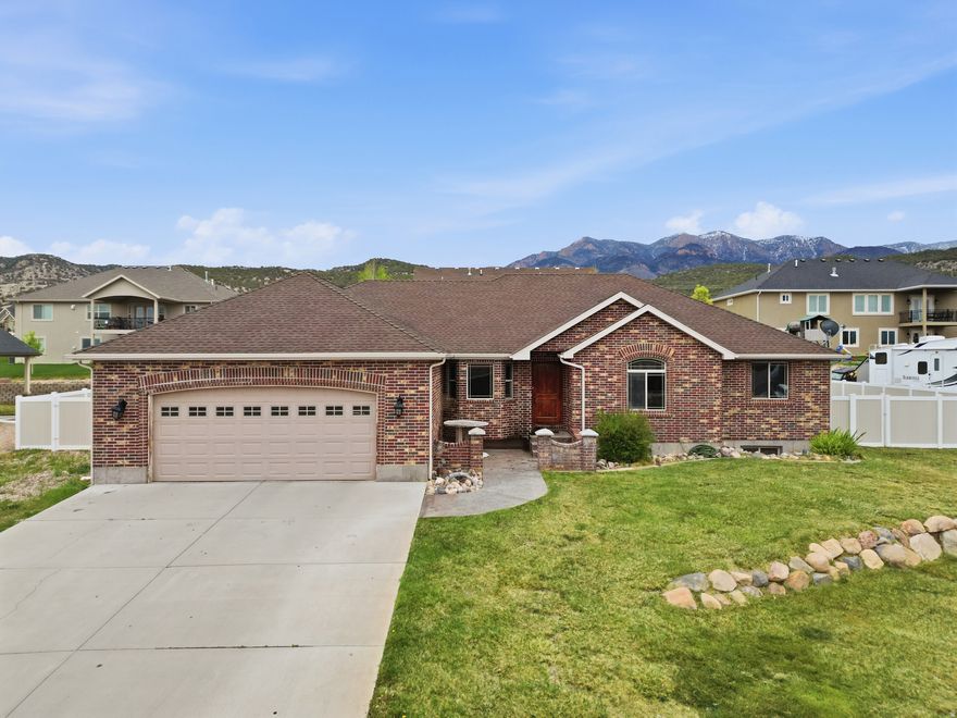 Beautifully upgraded home in a prime Nephi neighborhood, within walking distance to Red Cliffs Elementary! The open-concept main floor features a spacious great room with a gas fireplace and a custom kitchen equipped with solid surface counters, stainless appliances, dual spice racks, and a large island. Retreat to the master suite boasting a jetted tub and a double-head travertine shower. The fully finished basement is an entertainer's dream, offering a huge family room, wet bar, and a unique custom 3/4 bath. Enjoy the outdoors with a covered patio, massive RV parking, and a 2-car garage. Perfectly located near local restaurants with quick freeway access for easy commuting. This gorgeous, move-in-ready home is a must-see!