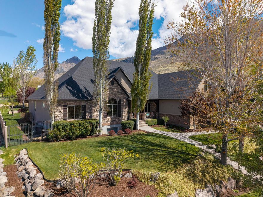 Nestled near the base of Mahogany Mountain in the Timpanogos Mountain Range on a quiet dead-end street, this stunning two-story home offers the perfect blend of privacy and breathtaking natural beauty. Inside, you'll find vaulted ceilings, gourmet kitchen, double ovens complete with a massive island-perfect for entertaining and everyday living, a main-floor primary suite with a large walk-in closet that has laundry hookups, a walk-out basement that opens to a secluded patio area ideal for relaxing or entertaining. With two full kitchens, a dedicated theater room (projector and theater equipment included), and potential for mother-in-law quarters or multi-generational living this home provides both comfort and versatility in an exceptional setting.  The property sits on a spacious -acre lot complete with a sports court and RV parking providing ample space for recreation and outdoor enjoyment.  NEW ROOF April 2026. Square footage figures are provided as a courtesy estimate only and were obtained from appraisal  Buyer is advised to obtain an independent measurement.