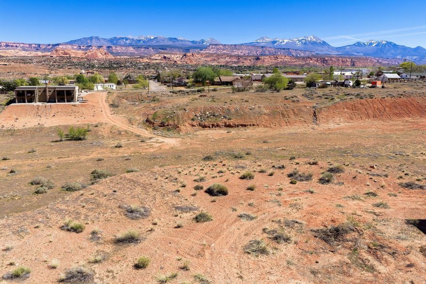 Commercial Opportunities Close to Downtown. Position your business for success with this commercial lot ideally located just four miles from downtown. Zoned Highway Commercial, this property offers flexibility for a wide range of development possibilities-retail, office space, sales and service, housing and more. Set against a stunning backdrop of the La Sal mountains and iconic red rock landscapes, this lot combines high visibility with stunning views. Billboard on property provides some income.