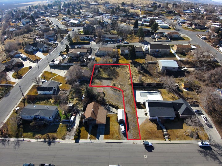 Aerial view of residential area with property boundaries highlighted