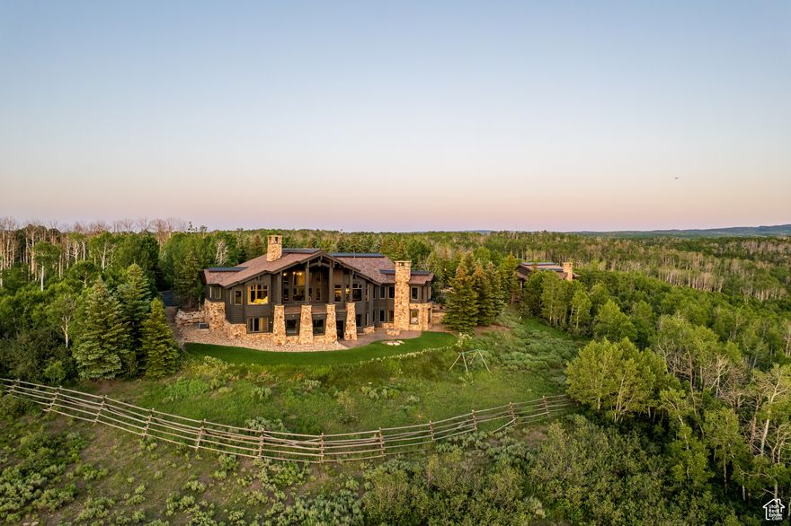 Welcome to Highpine Ranch, a newly transformed mountain estate set on 160 acres of quaking aspen and pine-covered wilderness in the prestigious gated enclave of Wolf Creek Ranch. Spanning 8,800 square feet, the residence was fully remodeled in 2025 with a vision rooted in simplicity, scale, and refined materials.  The heart of the home is a striking gourmet kitchen featuring luminous Cristallo quartzite countertops, known for their rare translucent clarity and organic veining. Custom White Oak cabinetry by Mar Wood pairs with a full suite of Wolf and SubZero appliances, elevating both utility and design. Five en-suite bedrooms, including a main-level primary suite, offer privacy and comfort, while wide-plank floors, sleek new fireplaces, and curated lighting throughout bring quiet sophistication to every room.  Technology and nature harmonize through a full AVS audio/video integration and Ketra dynamic lighting, which adjusts throughout the day to mirror natural daylight. Outdoors, expansive decks frame commanding views of Mt. Timpanogos, stretching across ridgelines and into protected wilderness. A heated barn enhances the property's versatility, with storage for up to 10 vehicles, a charming guest apartment, and direct access to private trails. Whether hosting, relaxing, or exploring, Highpine Ranch offers an extraordinary balance of architectural integrity, natural beauty, and quiet luxury, set within one of the Mountain West's most celebrated private land holdings.